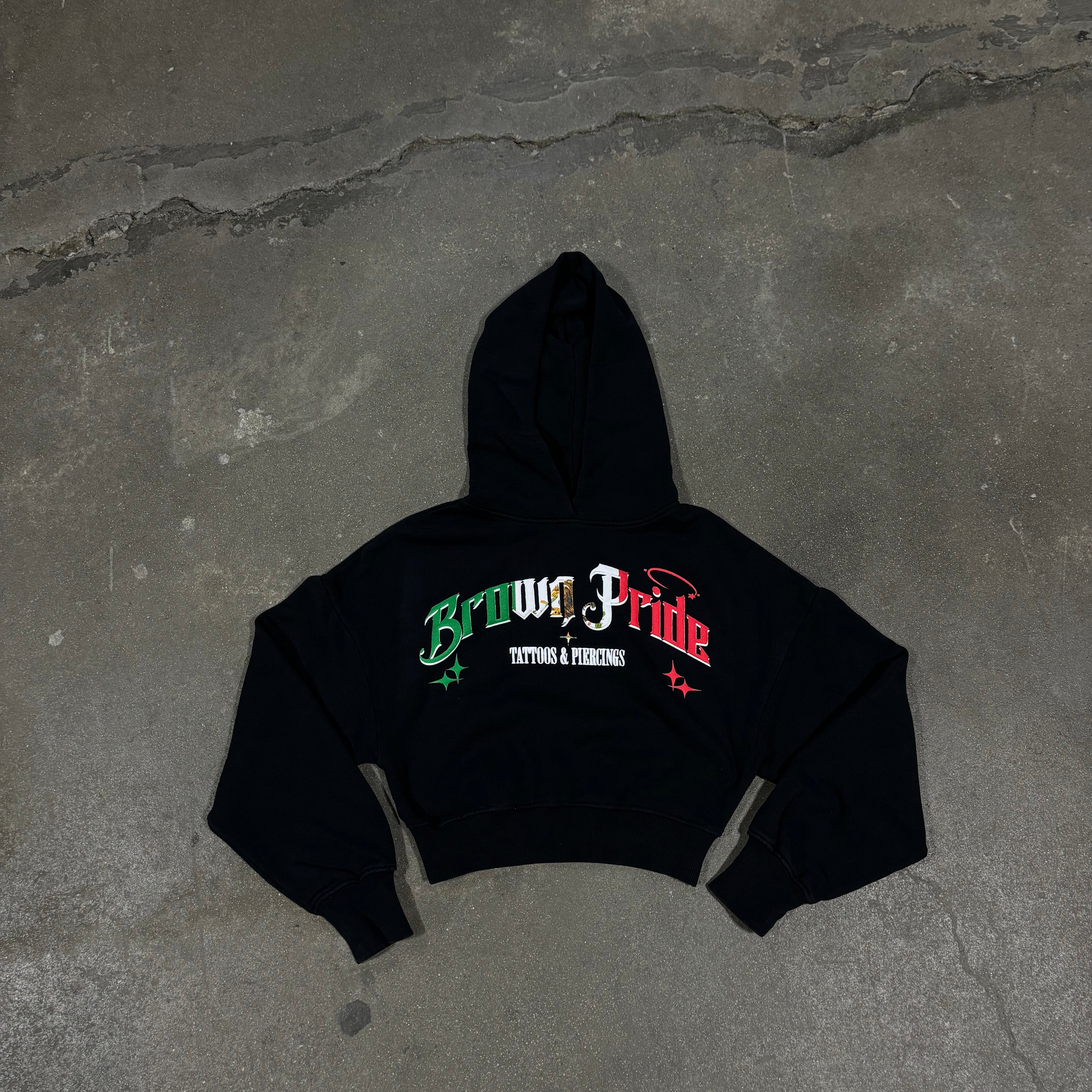 Black hoodie with text on a gray concrete surface