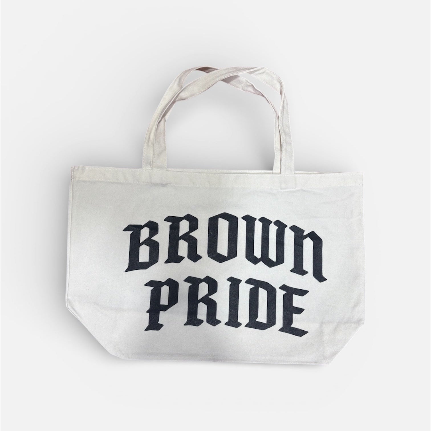 White tote bag with 'Brown Pride' text on a white background